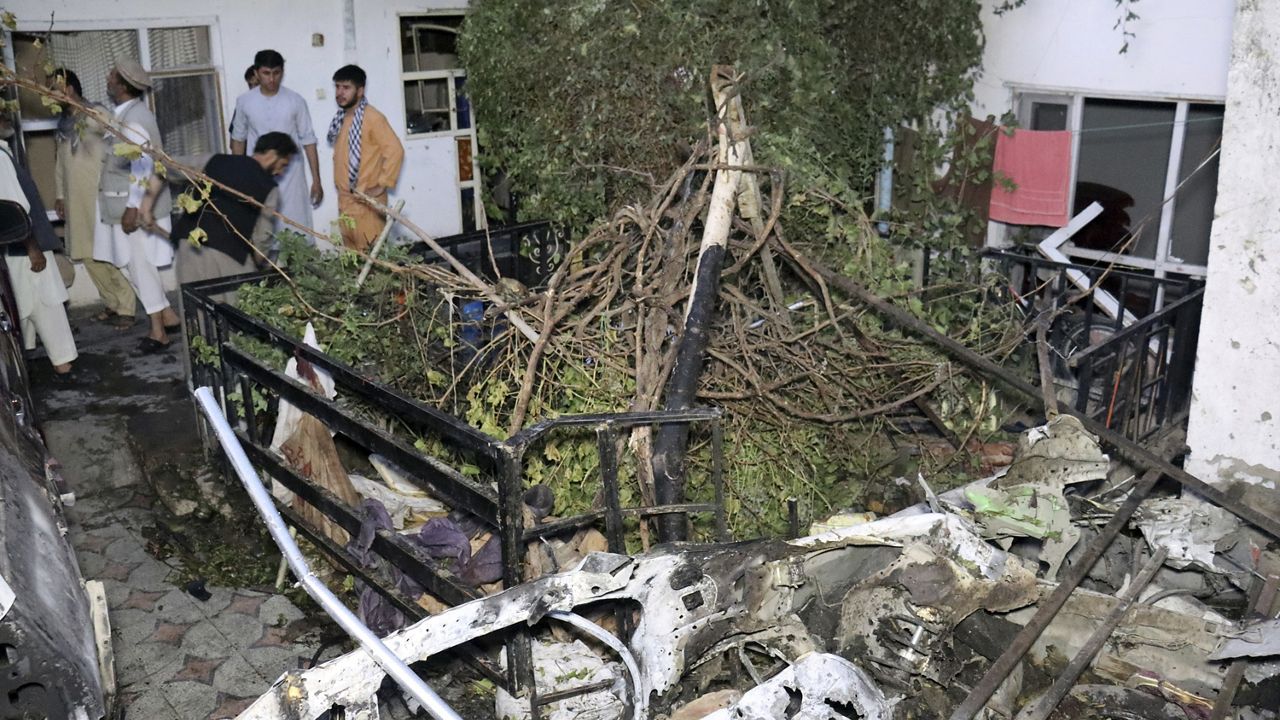 FILE - In this Sunday, Aug. 29, 2021 file photo, Afghans inspect damage of Ahmadi family house after U.S. drone strike in Kabul, Afghanistan, Sunday, Aug. 29, 2021. (AP Photo/Khwaja Tawfiq Sediqi, File)