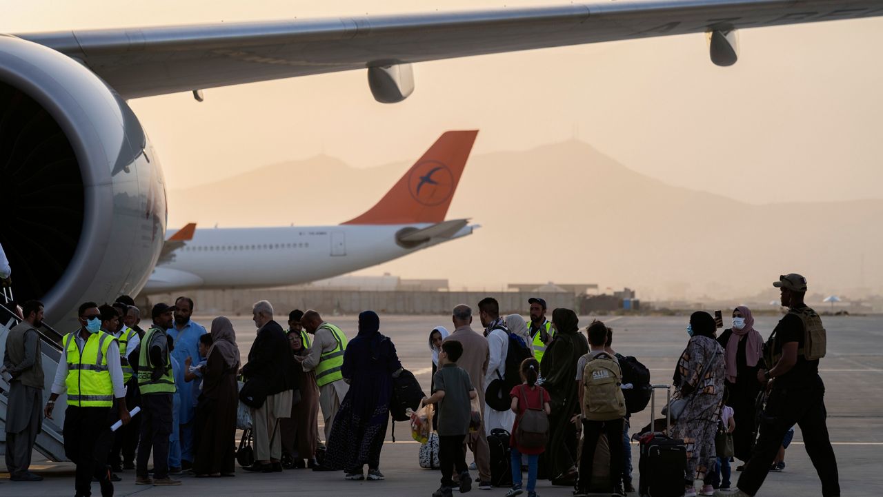 Foreigners board a Qatar Airways aircraft at the airport in Kabul, Afghanistan, Thursday, Sept. 9, 2021. (AP Photo/Bernat Armangue)