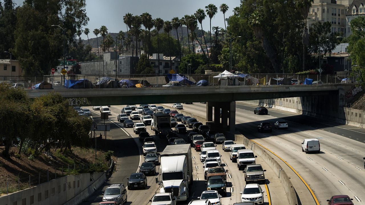 FILE - In this July 7, 2021, file photo homeless encampments are installed on an overpass of the CA-101 Hollywood freeway in Los Angeles. (AP Photo/Damian Dovarganes, File)