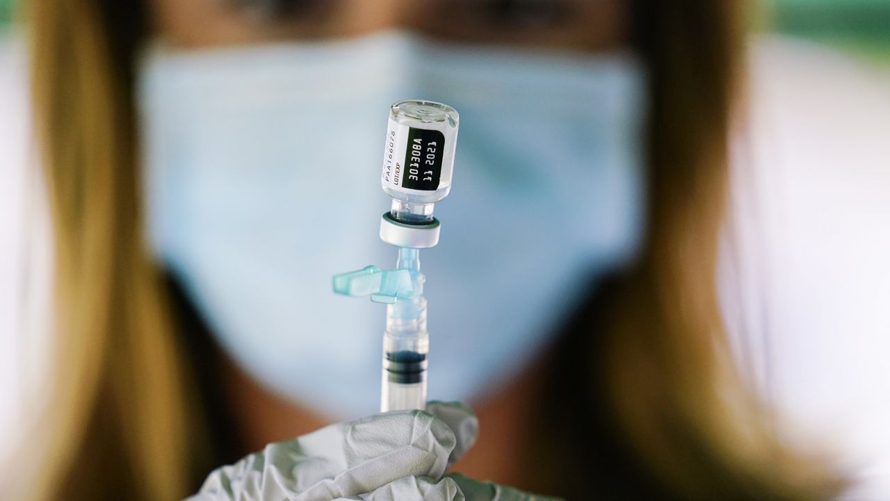 FILE - In this Sept. 14, 2021, file photo, a syringe is prepared with the Pfizer COVID-19 vaccine at a clinic at the Reading Area Community College in Reading, Pa. (AP Photo/Matt Rourke, File)