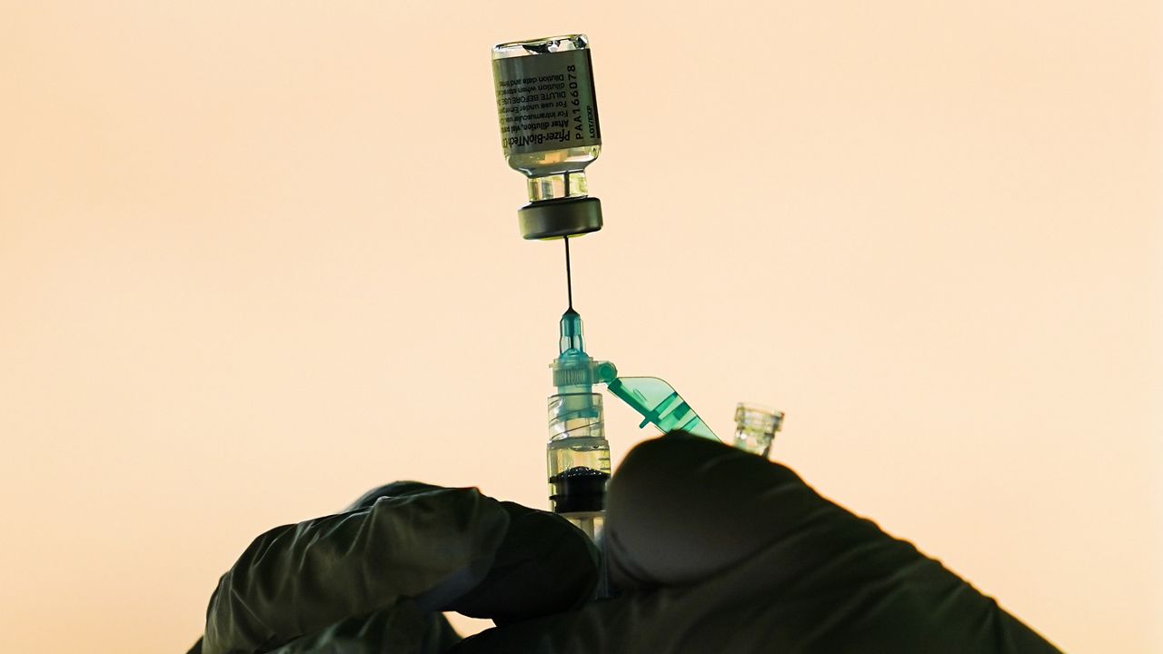 A syringe is prepared with the Pfizer COVID-19 vaccine at a clinic at the Reading Area Community College in Reading, Pa., Tuesday, Sept. 14, 2021. (AP Photo/Matt Rourke)