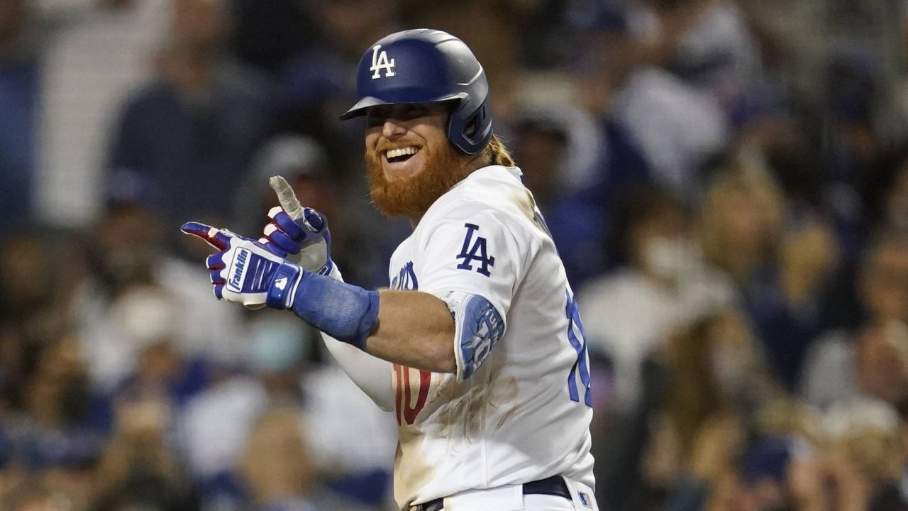 Los Angeles Dodgers' Justin Turner signals after hitting a home run during a baseball game against the Arizona Diamondbacks Monday, Sept. 13, 2021, in Los Angeles. (AP Photo/Marcio Jose Sanchez)