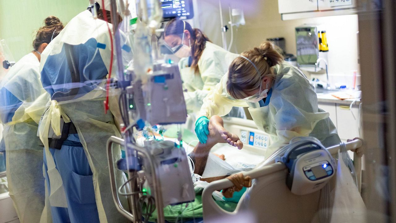 In this Aug. 31, 2021, file photo, medical professionals treat a COVID-19 patient in the medical intensive care unit at St. Luke's Boise Medical Center in Boise, Idaho. (AP Photo/Kyle Green,File)