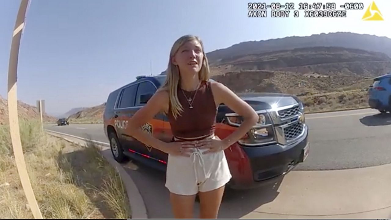This police camera video provided by The Moab Police Department shows Gabrielle “Gabby” Petito talking to a police officer after police pulled over the van she was traveling in with her boyfriend, Brian Laundrie, near the entrance to Arches National Park on Aug. 12, 2021. (The Moab Police Department via AP)