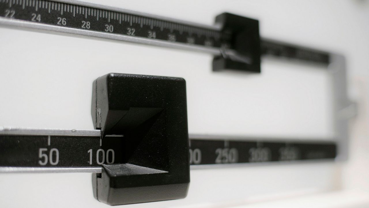 This Tuesday, April 3, 2018 file photo shows a closeup of a beam scale in New York. A study by the U.S. Centers for Disease Control and Prevention released on Thursday, Sept. 16, 2021, ties the COVID-19 pandemic to an “alarming” increase in obesity in U.S. children and teenagers. (AP Photo/Patrick Sison, File)