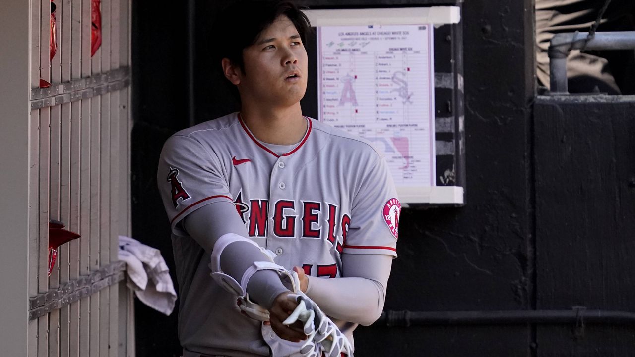 Los Angeles Angels designated hitter Shohei Ohtani, of Japan, looks to the field in the dugout after striking out swinging during the third inning of a baseball game against the Chicago White Sox in Chicago, Thursday, Sept. 16, 2021. (AP Photo/Nam Y. Huh)