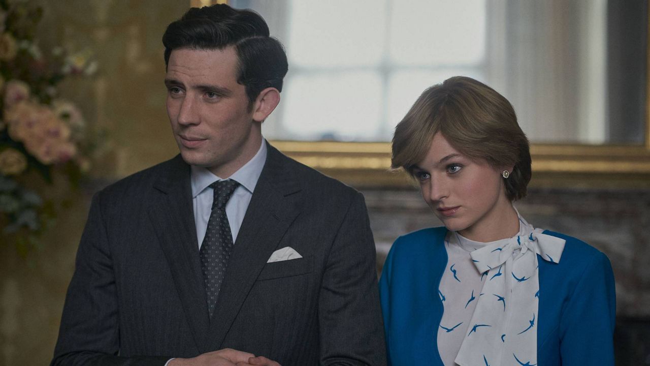This image released by Netflix shows Josh O'Connor, left, and Emma Corrin in a scene from "The Crown." (Des Willie/Netflix via AP)