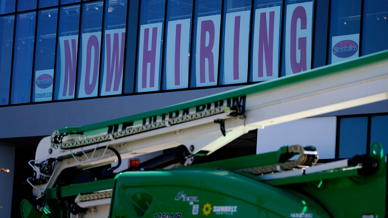 A hiring sign is displayed at a furniture store window on Sept. 17, 2021, in Downers Grove, Ill. (AP Photo/Nam Y. Huh)