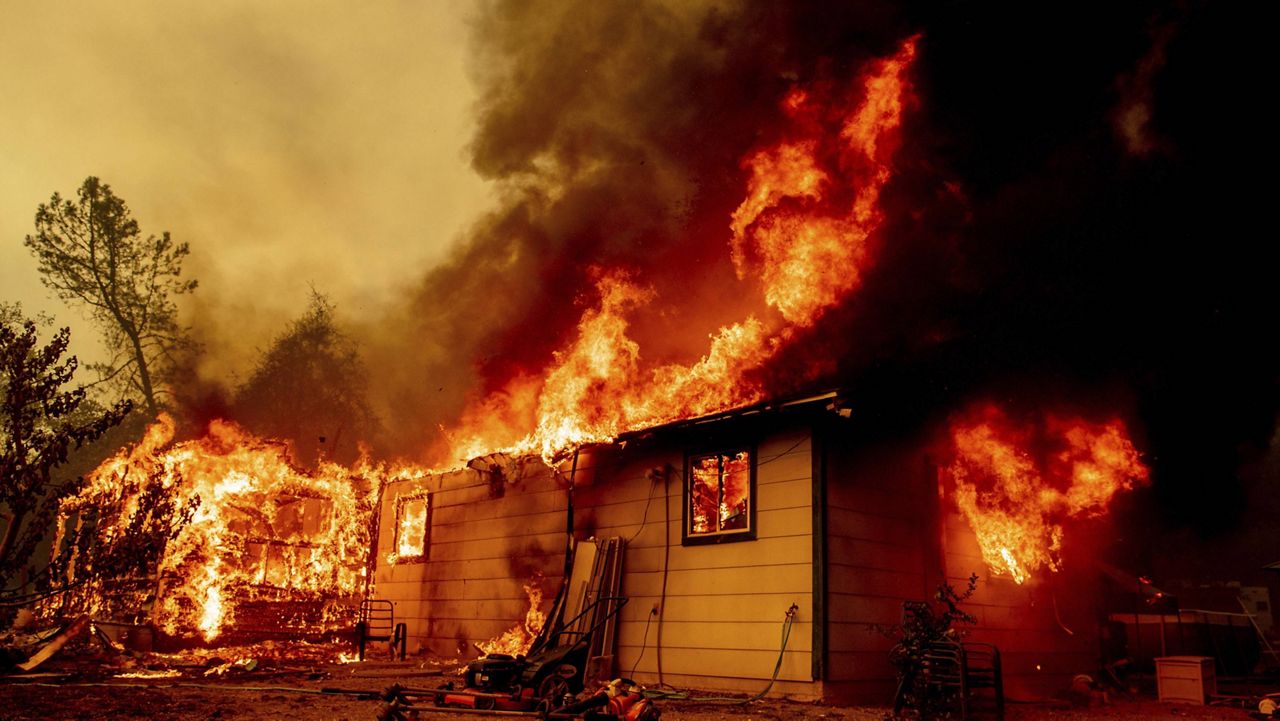 Flames consume a house near Old Oregon Trail as the Fawn Fire burns about 10 miles north of Redding in Shasta County, Calif., on Thursday, Sep. 23, 2021. (AP Photo/Ethan Swope)