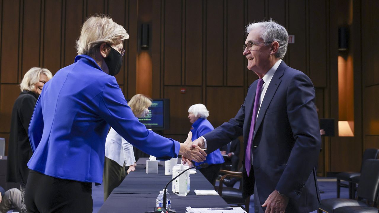 Sen. Elizabeth Warren, D-Mass., greets Federal Reserve Chairman Jerome Powell before a Senate Banking, Housing and Urban Affairs Committee hearing on the CARES Act on Capitol Hill, Tuesday, Sept. 28, 2021 in Washington. (Kevin Dietsch/Pool via AP)