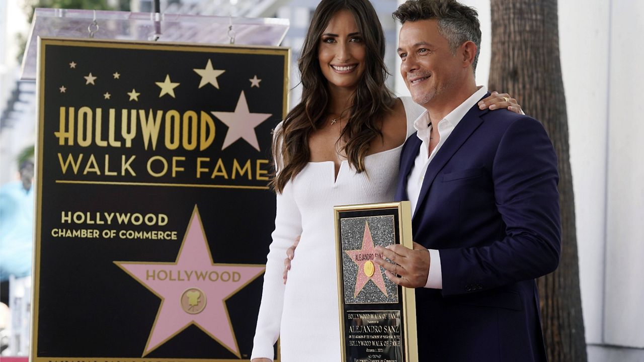 Spanish musician Alejandro Sanz poses with girlfriend Rachel Valdes after he received a star on the Hollywood Walk of Fame, Friday, Oct. 1, 2021, in Los Angeles. (AP Photo/Chris Pizzello)
