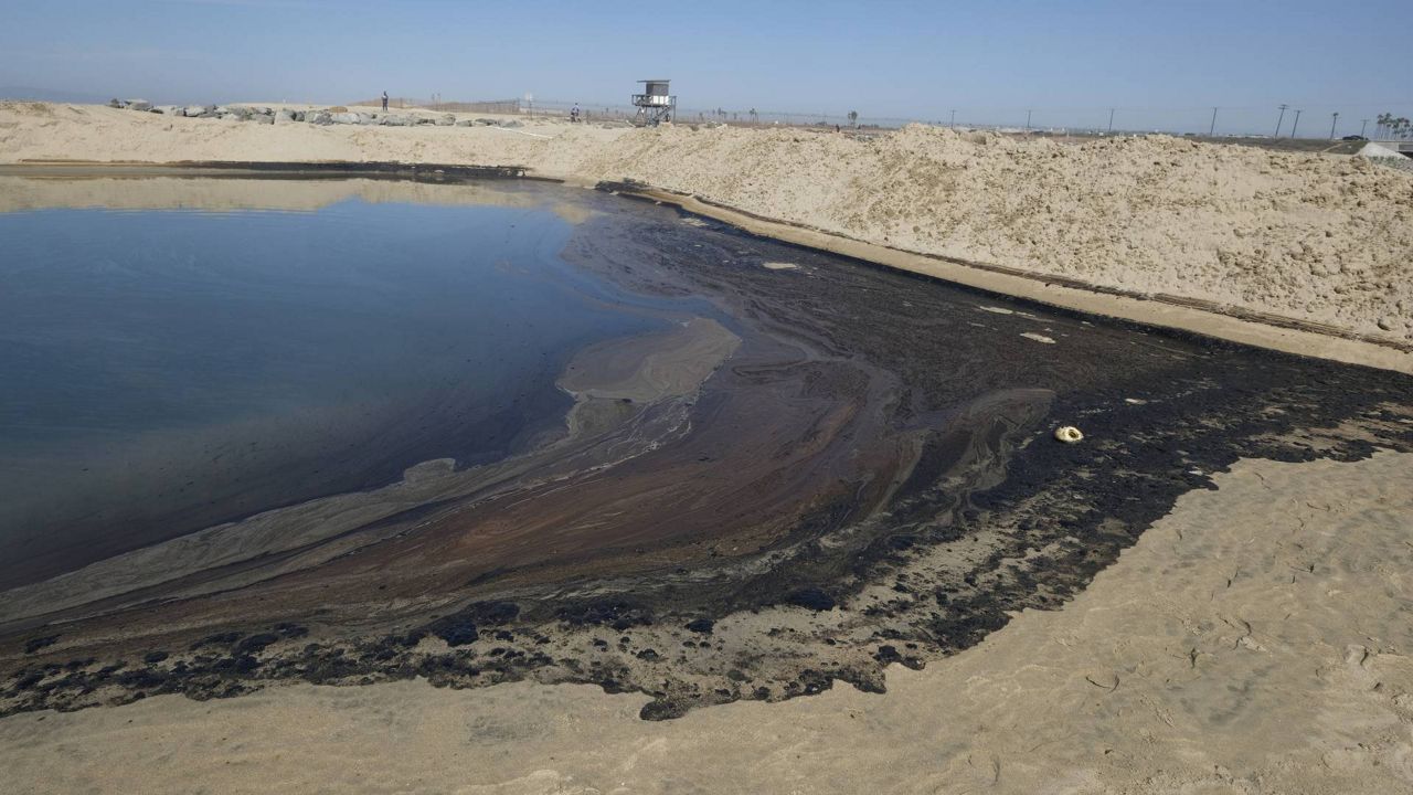 Oil is shown washed up in Huntington Beach, Calif., Sunday, Oct. 3, 2021. (AP Photo/Ringo H.W. Chiu)