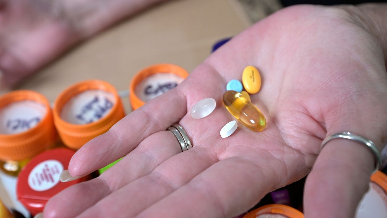 Retiree Donna Weiner shows some of the daily prescription medications that she needs and pays over $6,000 a year through a Medicare prescription drug plan at her home, Tuesday, Oct. 5, 2021, in Longwood, Fla. (AP Photo/Phelan M. Ebenhack)