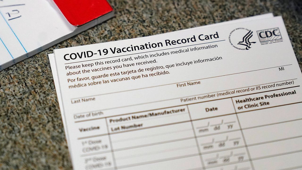 In this Dec. 24, 2020, file photo, a COVID-19 vaccination record card is shown at Seton Medical Center in Daly City, Calif. 