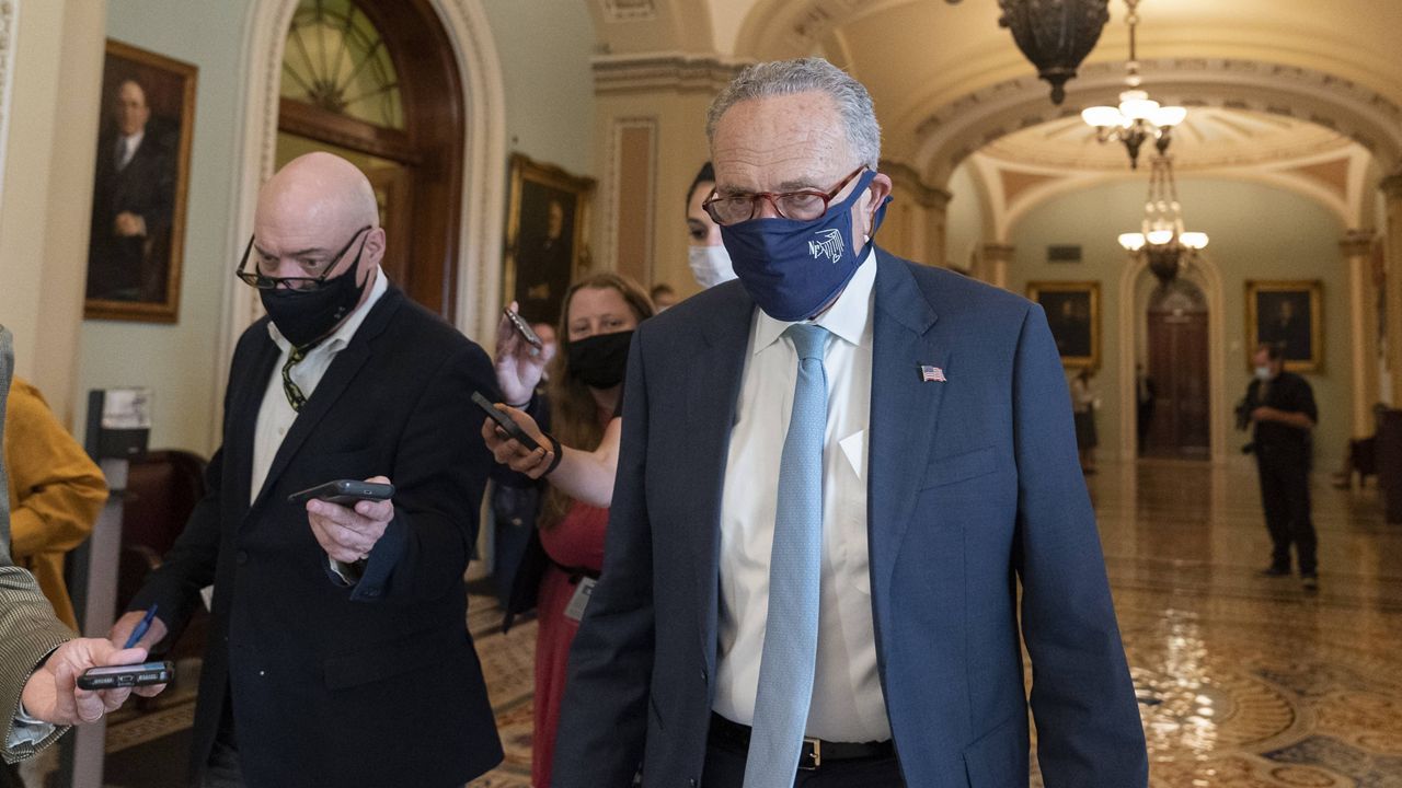 Senate Majority Leader Chuck Schumer speaks with reporters Thursday as he walks to his office on Capitol Hill. (AP Photo/Alex Brandon)