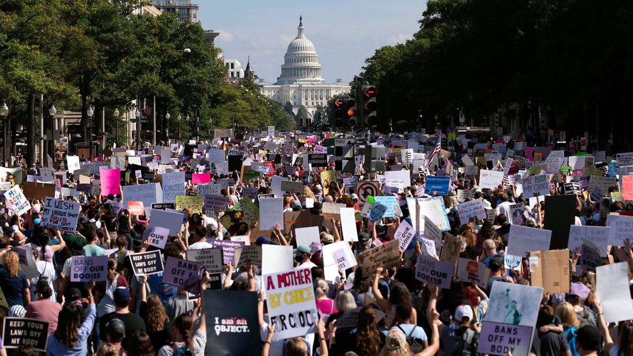 With the U.S Capitol in the background, thousands of demonstrators march on Pennsylvania Avenue during the Women's March in Washington, Saturday, Oct. 2, 2021. (AP Photo/Jose Luis Magana)