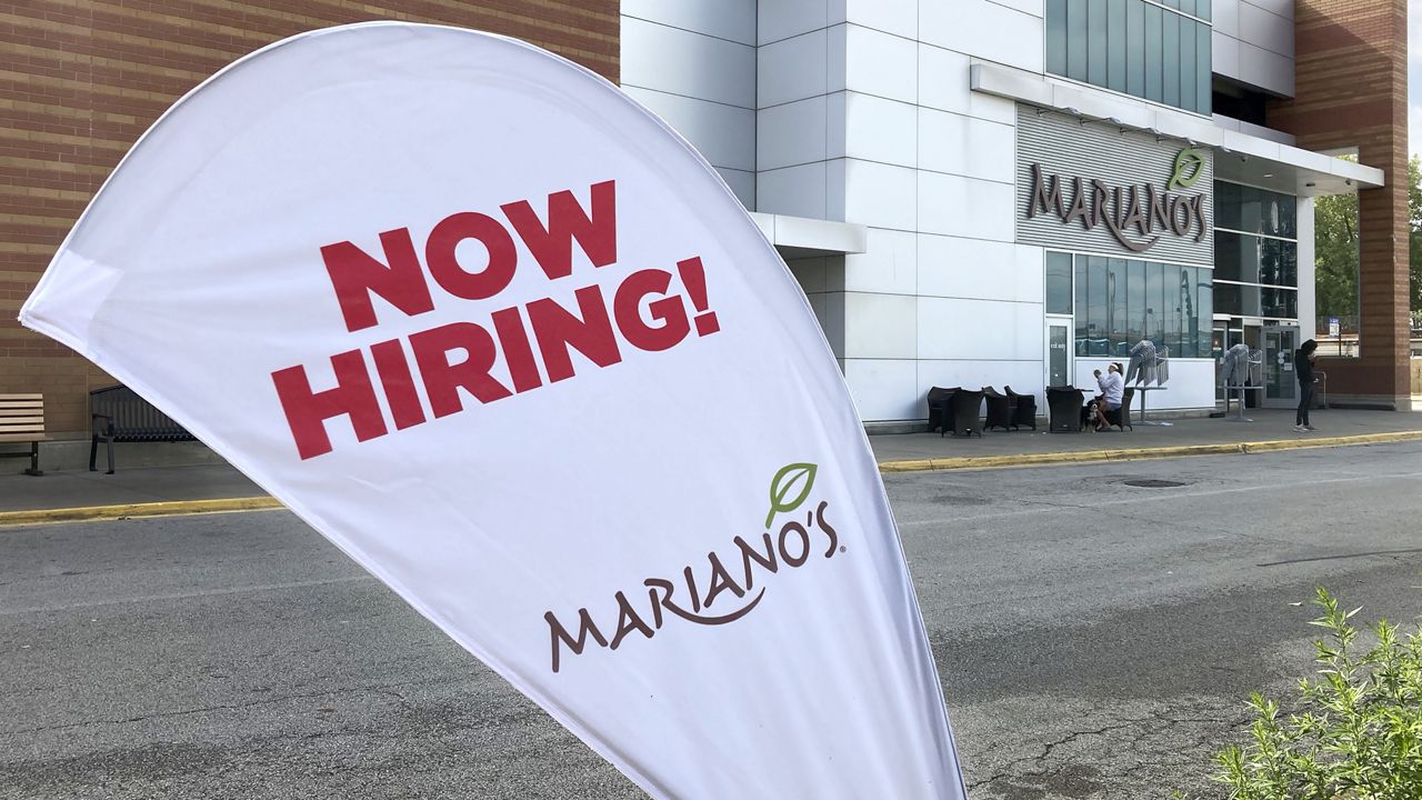 A sign in the parking lot of Mariano's grocery store advertises the availability of jobs Friday, Oct. 8, 2021, in Chicago. (AP Photo/Charles Rex Arbogast)