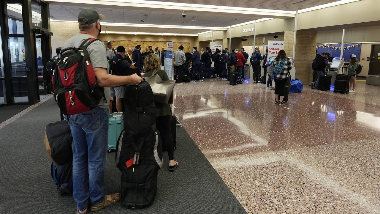 Passengers line up at the ticketing counter for Southwest Airlines flights Sunday at Eppley Airfield in Omaha, Neb. (AP Photo/David Zalubowski)