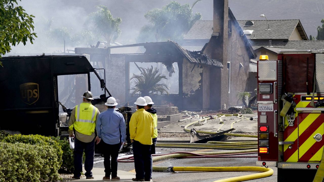 Fire and safety crews work the scene of a plane crash, Monday, Oct. 11, 2021, in Santee, Calif. (AP Photo/Gregory Bull)