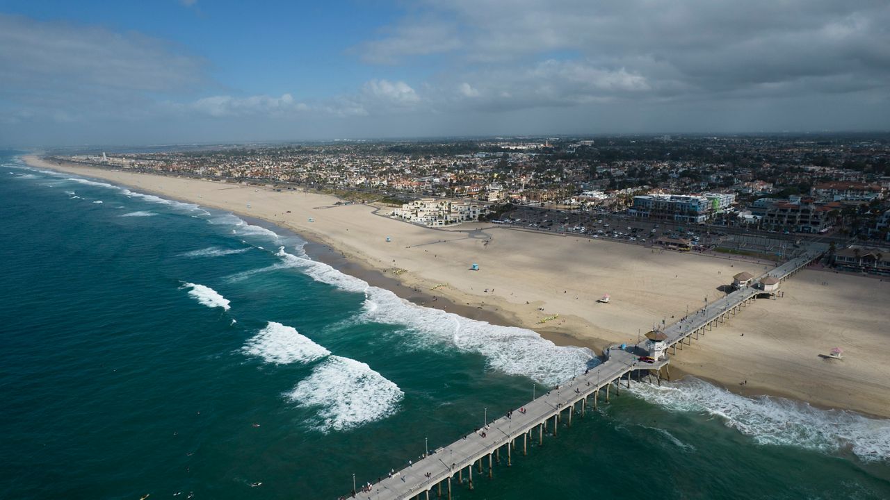 This aerial photo shows a beach in Huntington Beach, Calif., Monday, Oct. 11, 2021. (AP Photo/Ringo H.W. Chiu)