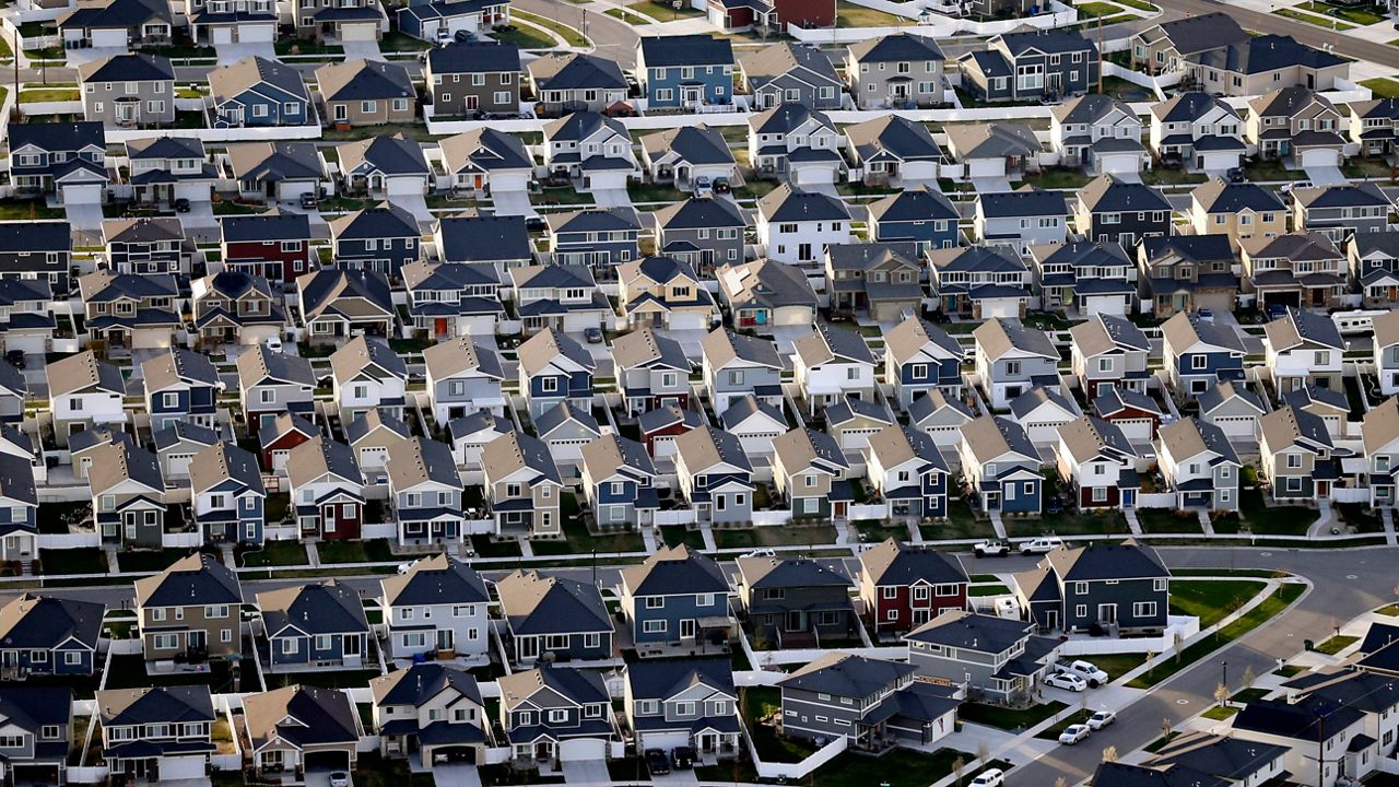 FILE - This April 13, 2019, file photo, shows rows of homes, in suburban Salt Lake City. (AP Photo/Rick Bowmer, File)