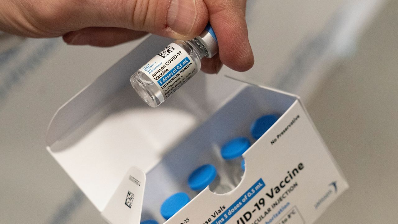 FILE - In this Wednesday, March 3, 2021 file photo, a pharmacist holds a vial of the Johnson & Johnson COVID-19 vaccine at a hospital in Bay Shore, N.Y. (AP Photo/Mark Lennihan)