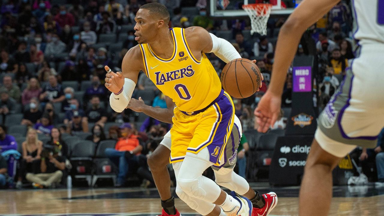 Los Angeles Lakers guard Russell Westbrook (0) dribbles the ball up the court against the Sacramento Kings during an NBA game in Sacramento, Calif., Thursday, Oct. 14, 2021. (AP Photo/Randall Benton)