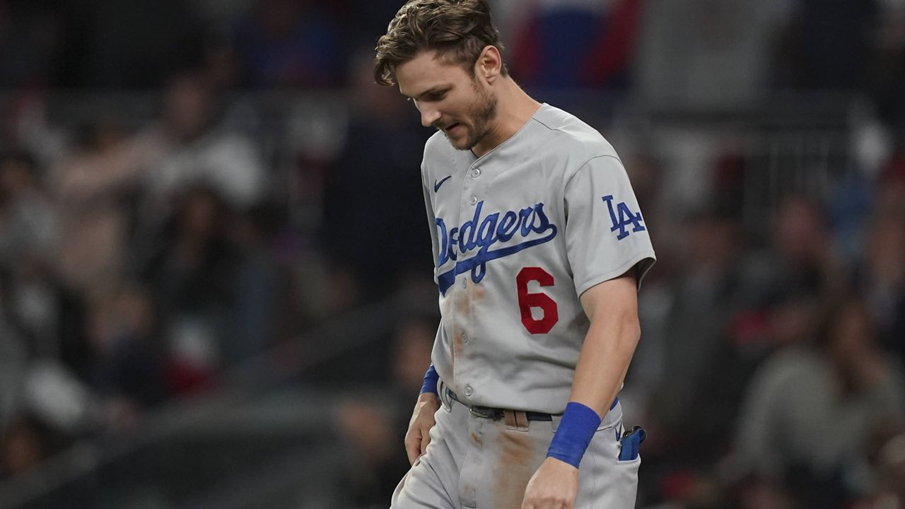 Los Angeles Dodgers' Trea Turner reacts after striking out in the seventh inning against the Atlanta Braves in Game 1 of baseball's National League Championship Series Saturday, Oct. 16, 2021, in Atlanta. (AP Photo/Brynn Anderson)