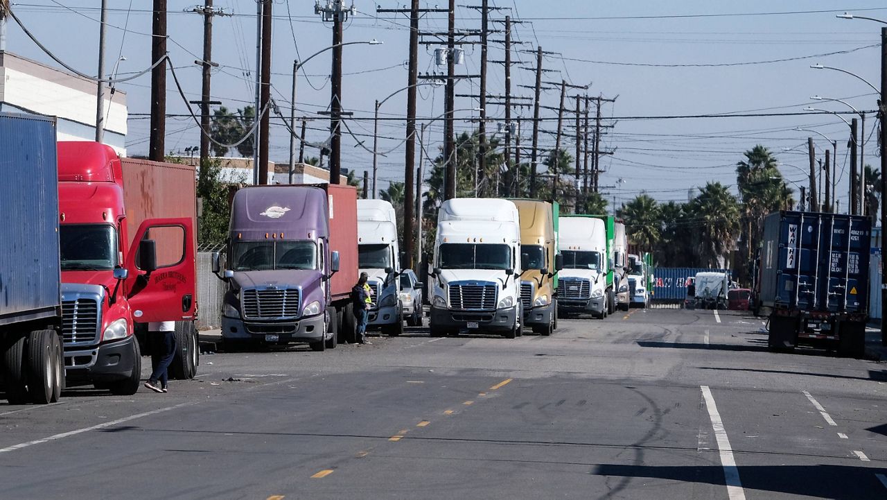 Parked cargo container trucks are seen in a street, Wednesday, Oct. 20, 2021 in Wilmington, Calif. (AP Photo/Ringo H.W. Chiu)