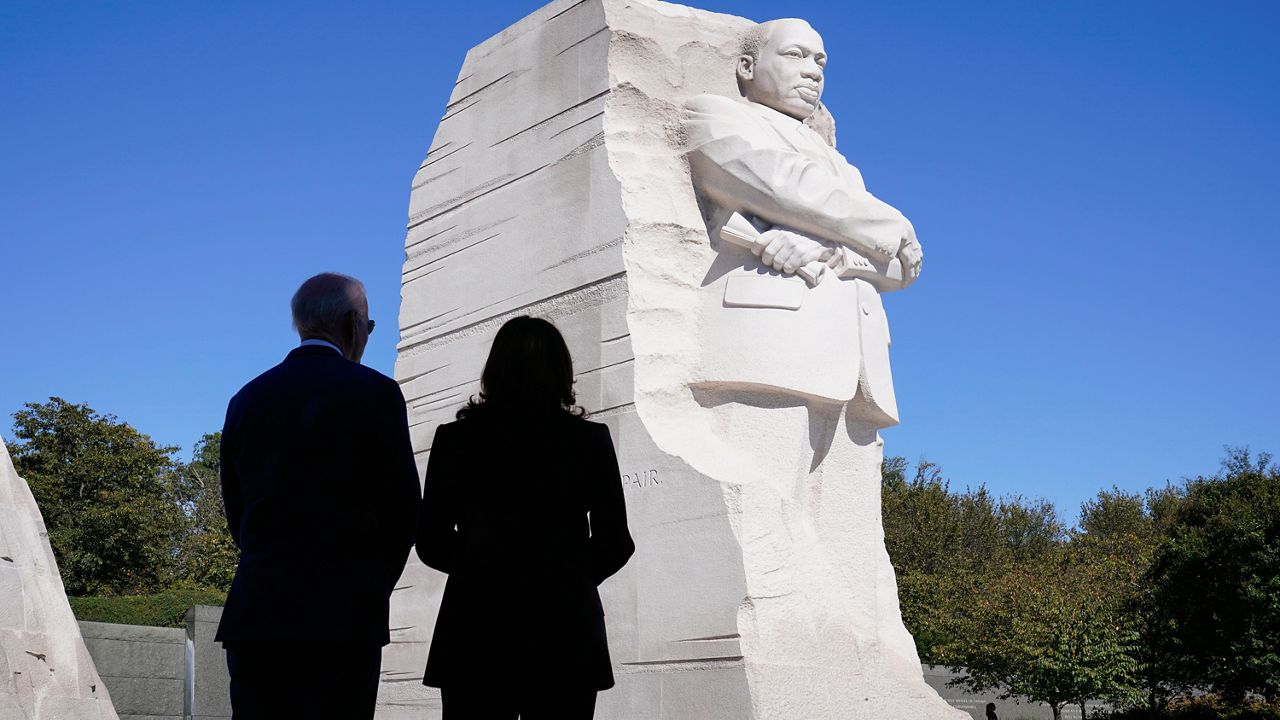 President Joe Biden and Vice President Kamala Harris stand together at the Martin Luther King, Jr. Memorial as they arrive to attend an event marking the 10th anniversary of the dedication of memorial in Washington, Thursday, Oct. 21, 2021. (AP Photo/Susan Walsh)