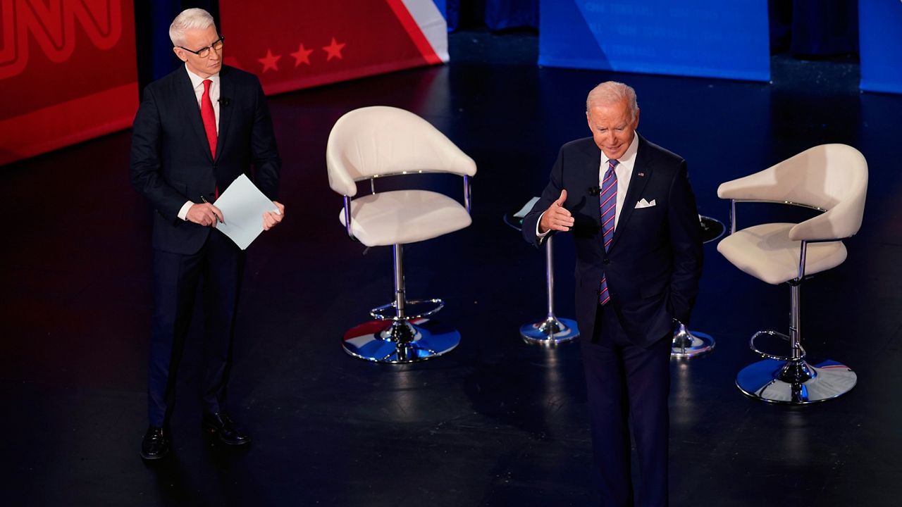 President Joe Biden participates in a CNN town hall at the Baltimore Center Stage Pearlstone Theater, Thursday, Oct. 21, 2021, in Baltimore, with moderator Anderson Cooper. (AP Photo/Evan Vucci)