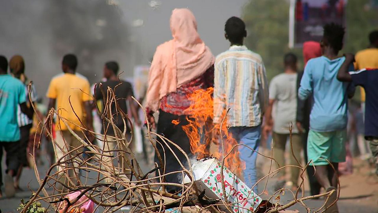 Pro-democracy protesters use fires to block streets to condemn a takeover by military officials in Khartoum, Sudan, Monday Oct. 25, 2021. (AP Photo/Ashraf Idris