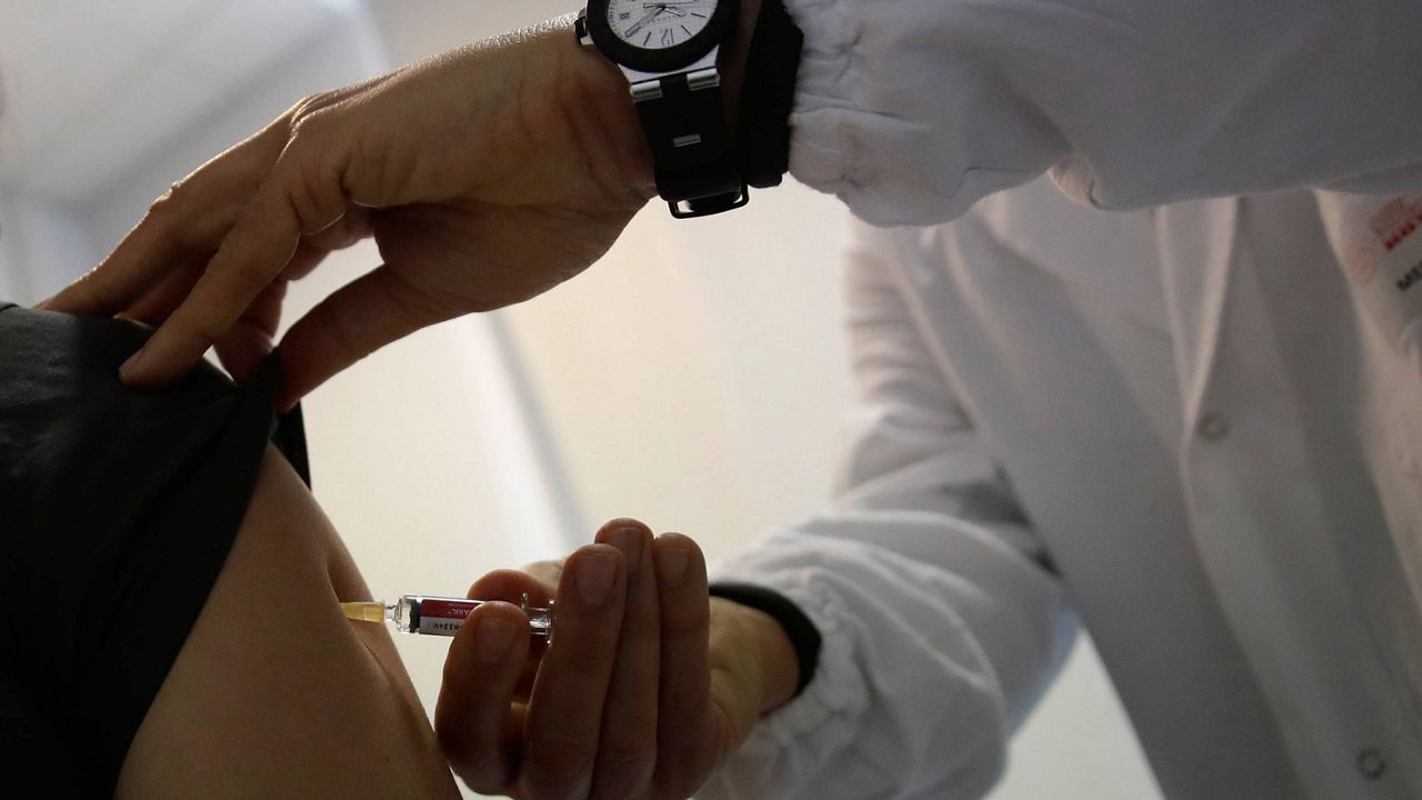 A doctor administers a COVID-19 vaccine to a woman. (AP Photo/Alessandra Tarantino, File)