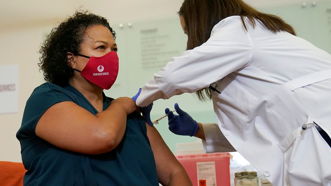 Assemblymember Mia Bonta receives a Moderna COVID-19 vaccine booster shot from Dr. Mychi Nguyen at Asian Health Services in Oakland, Calif., Wednesday, Oct. 27, 2021. (AP Photo/Jeff Chiu)