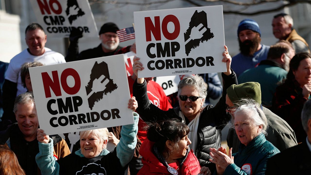 Opponents of a proposed $1 billion transmission line aimed at bringing Canadian hydropower to the New England grid attend a rally Feb. 3, 2020, in Augusta, Maine. (AP Photo/Robert F. Bukaty, file)