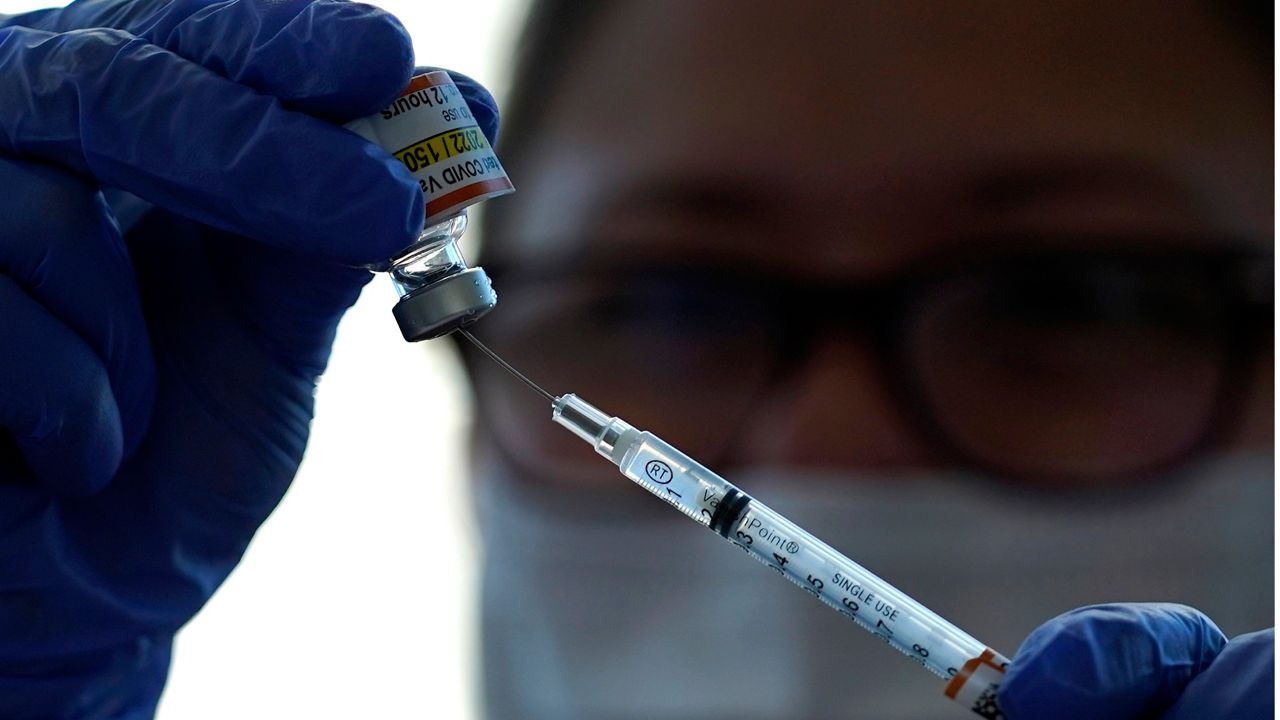 Lurie Children's hospital registered nurse Carolyn Ruyle prepares a dose of a Pfizer COVID-19 vaccine at Lurie Children's hospital Friday, Nov. 5, 2021, in Chicago. (AP Photo/Nam Y. Huh)