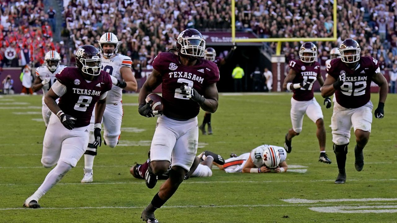 Texas A&M defensive lineman Micheal Clemons (2) returns a fumble by Auburn quarterback Bo Nix (10) for a touchdown during the second half of an NCAA college football game Saturday, Nov. 6, 2021, in College Station, Texas. Texas A&M won 20-3. (AP Photo/David J. Phillip)