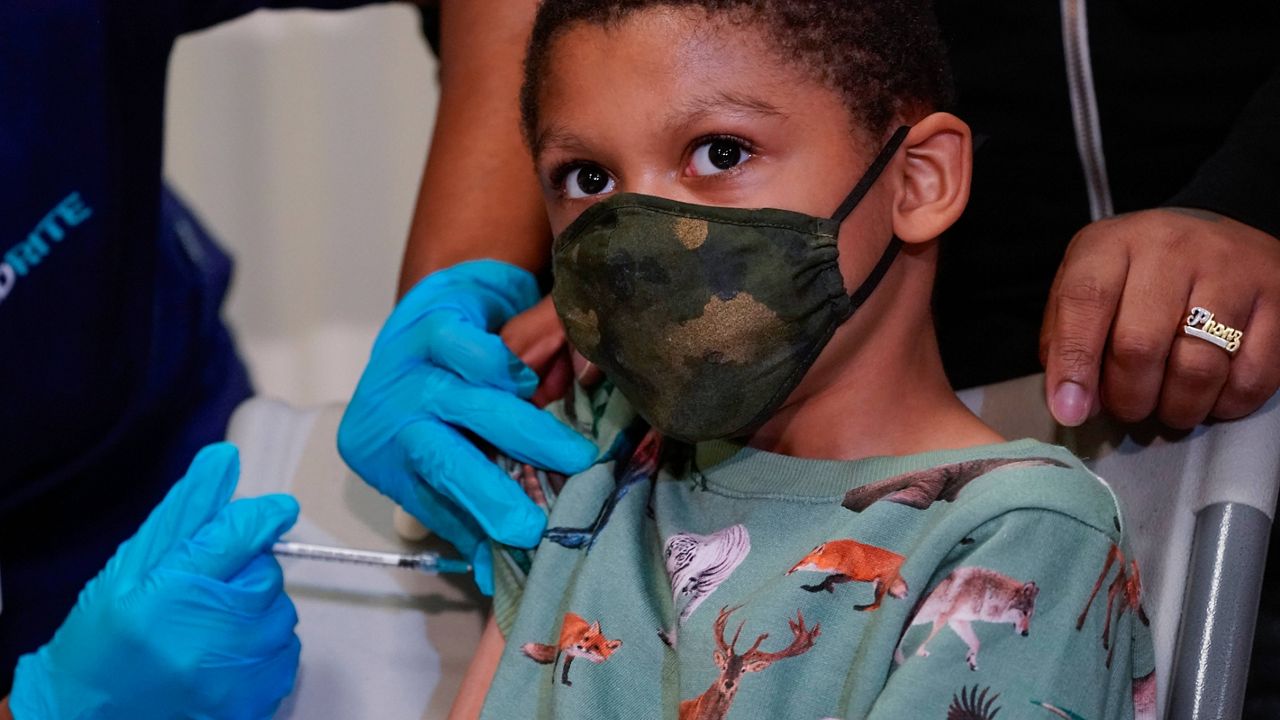 Christopher Reyes, 9, is inoculated with the first dose of the Pfizer-BioNTech COVID-19 vaccine for children ages 5 to 12 on Nov. 8 at P.S. 19 in New York. (AP Photo/Mary Altaffer)