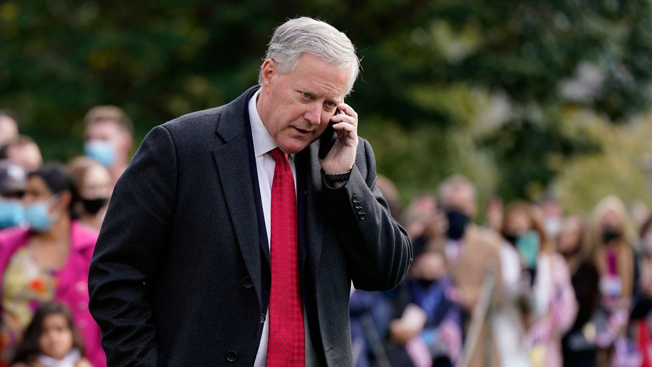 FILE - White House chief of staff Mark Meadows speaks on a phone on the South Lawn of the White House in Washington, on Oct. 30, 2020. (AP Photo/Patrick Semansky, File)