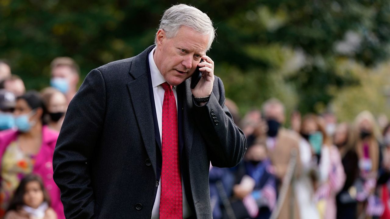 FILE - White House chief of staff Mark Meadows speaks on a phone on the South Lawn of the White House in Washington, on Oct. 30, 2020. (AP Photo/Patrick Semansky, File)