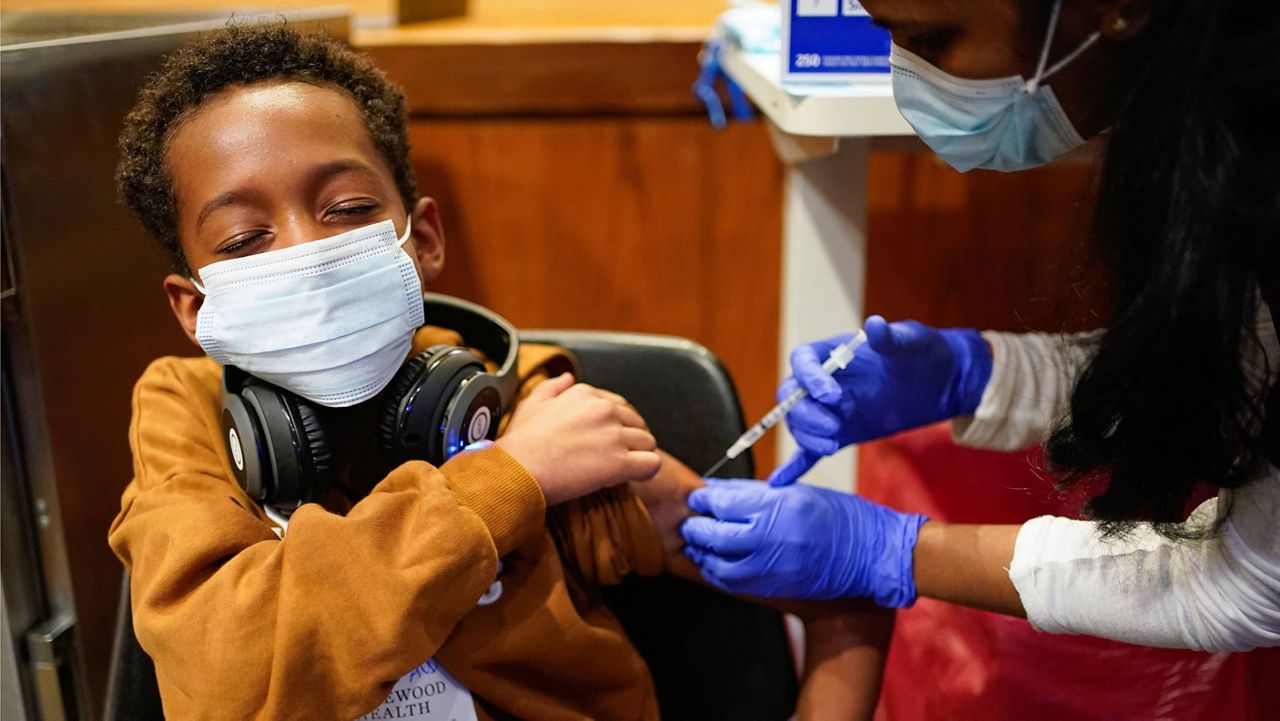 Cameron West, 9, receives the COVID-19 vaccine at Englewood Health in Englewood, N.J., on Nov. 8. (AP Photo/Seth Wenig, File)
