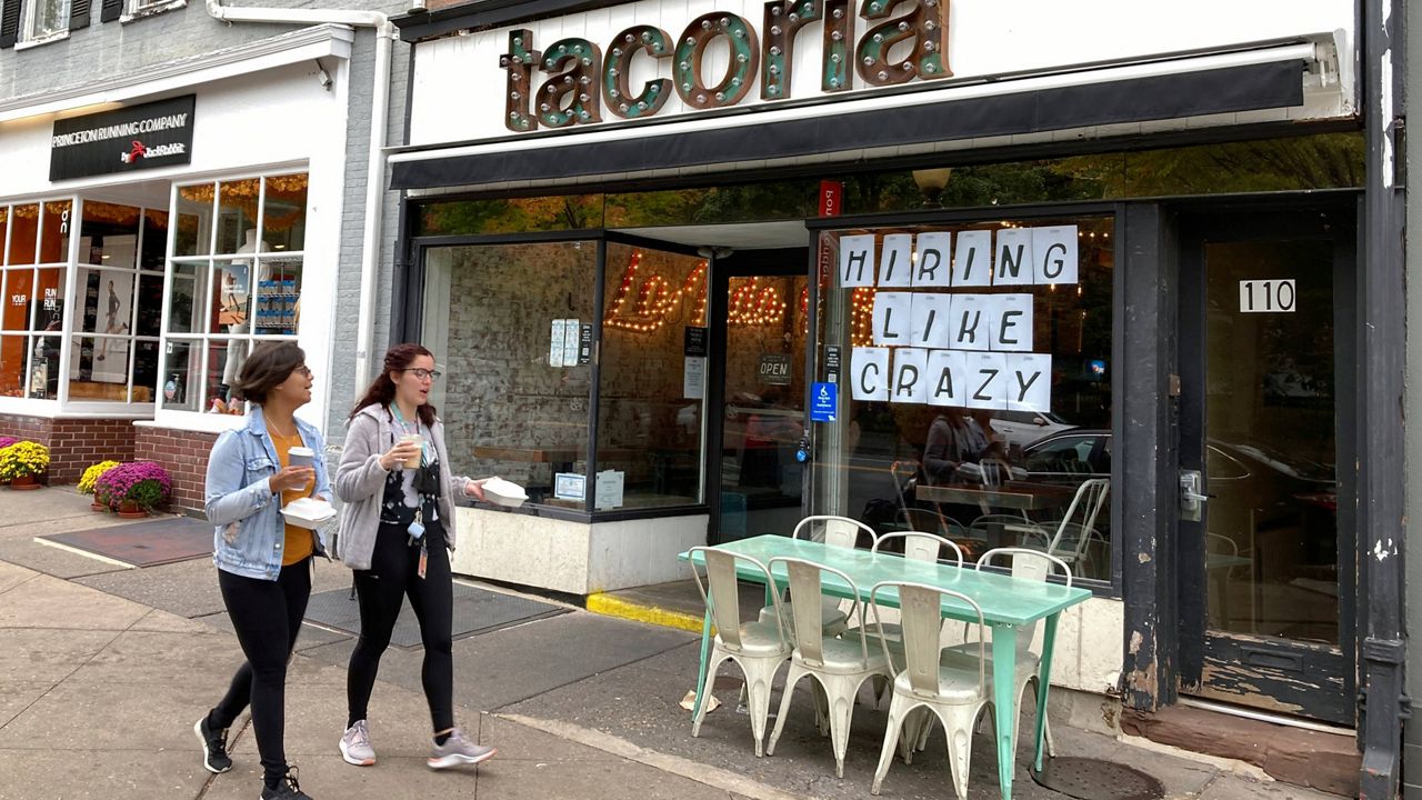 A sign reads "Hiring Like Crazy" is seen in the front window of a taco restaurant in Princeton, New Jersey, on Oct. 5. (AP Photo/Ted Shaffrey, File)