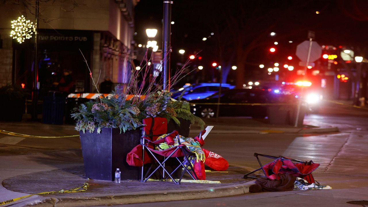 Toppled chairs are seen among holiday decorations in downtown Waukesha, Wis., after an SUV plowed into a Christmas parade injuring dozens of people Sunday, Nov 21. 2021. (AP Photo/Jeffrey Phelps)