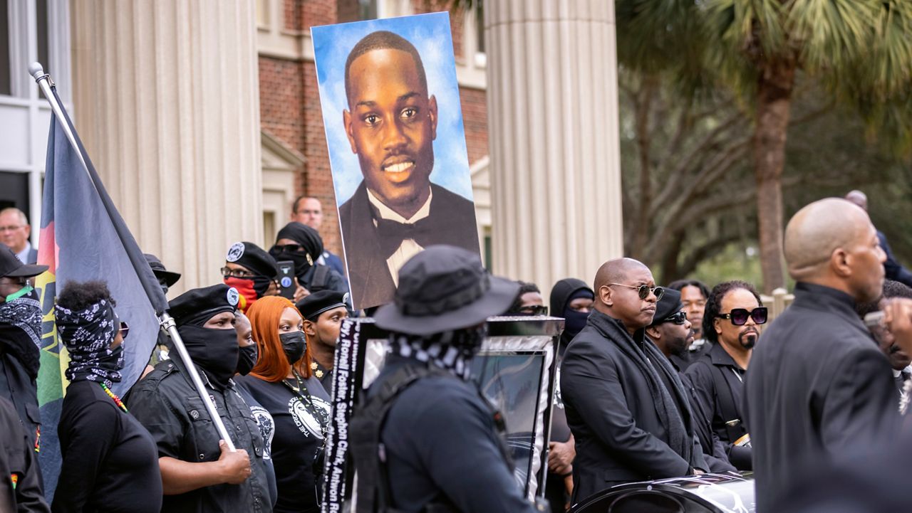 Dozens of Black Lives Matter and Black Panther protesters gather outside the Glynn County Courthouse where the trial of Travis McMichael, his father, Gregory McMichael, and William "Roddie" Bryan is held, Monday, Nov. 22, 2021, in Brunswick, Ga. The three men charged with the February 2020 slaying of 25-year-old Ahmaud Arbery. (AP Photo/Stephen B. Morton)