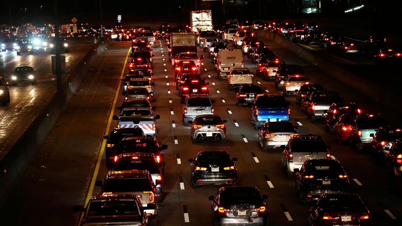 Motorists sit in heavy traffic southbound on Interstate 25 at Franklin Street as the Thanksgiving Day holiday approaches Tuesday, Nov. 23, 2021, in Denver. (AP Photo/David Zalubowski)