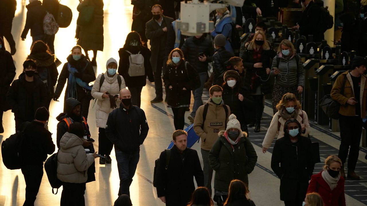 Commuters walk through Waterloo train station in London during the morning rush hour after disembarking from a train Monday. (AP Photo/Matt Dunham)