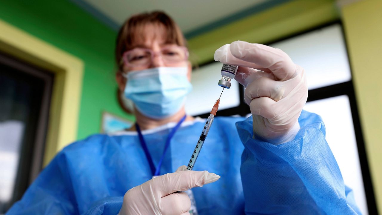 A nurse prepares a syringe with the Pfizer COVID-19 vaccine in Tirana, Albania. (AP Photo/Franc Zhurda)