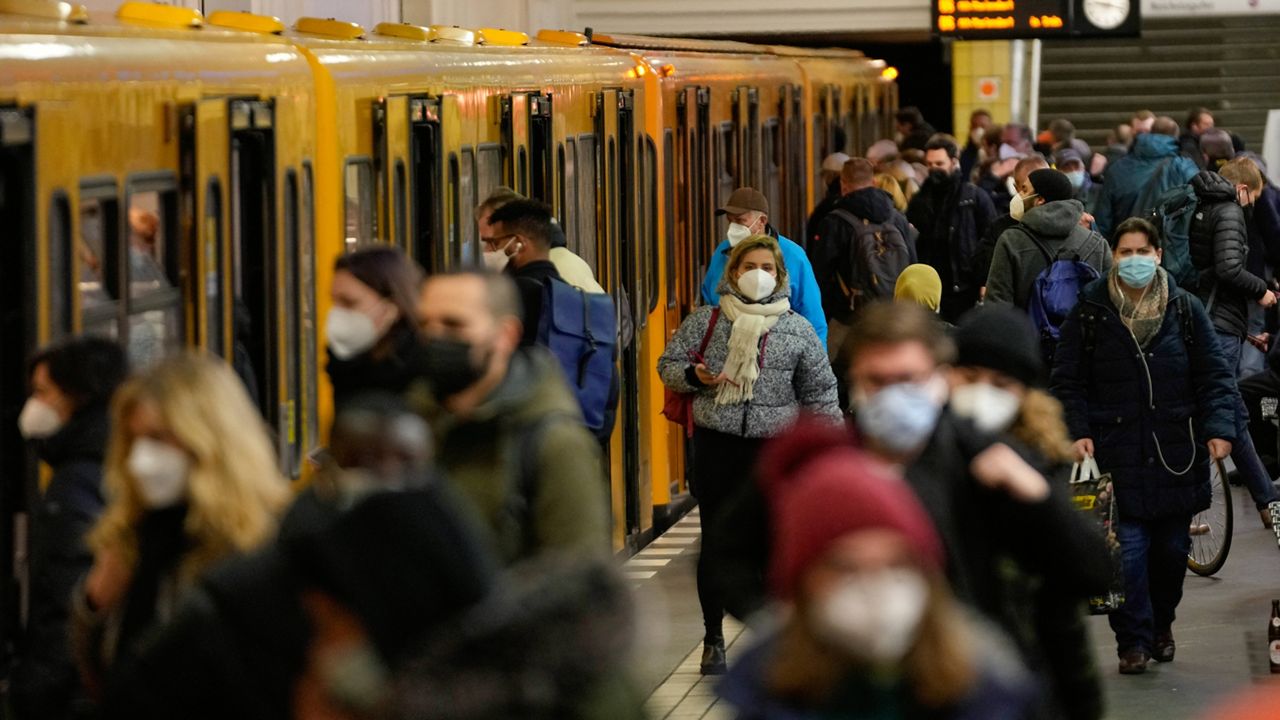 People wear face masks to protect against the coronavirus Tuesday at the public transport station Friedrichstrasse in Berlin. (AP Photo/Markus Schreiber)