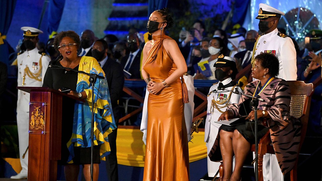 Barbados Prime Minister Mia Mottley, left, and President Dame Sandra Mason, right, honor Rihanna as a national hero Tuesday in Bridgetown, Barbados. (Jeff J Mitchell PA via AP)