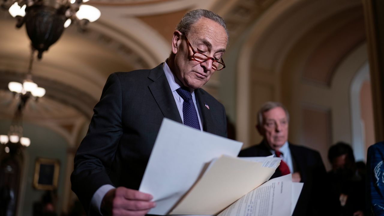 Senate Majority Leader Chuck Schumer, D-N.Y., looks over his notes as he prepares to speak to reporters after a Democratic policy meeting at the Capitol in Washington, Tuesday, Nov. 2, 2021. (AP Photo/J. Scott Applewhite)